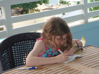 Writing in her journal on our balcony at Beaches Boscobel